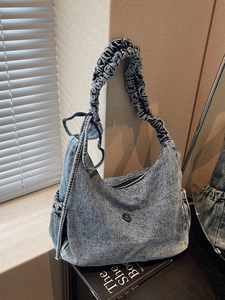 Retro washed denim hobo bag with pleated shoulder strap and round metal logo
