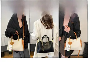 Vue détaillée du grand sac à main en cuir souple avec pendentif cœur et bandoulière