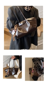 Dark brown high-gloss tote bag with bear charm detail and silver hardware accents