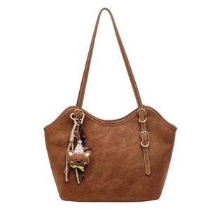 Brown vintage faux suede tote bag with wavy edges and a cute bear pendant decoration