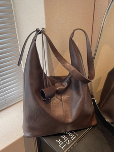 Retro dark brown faux leather tote bag with vertical stitching and round charm