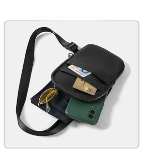 Detailed internal view of black crossbody bag showing slots for phone and cards
