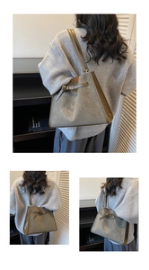 Detail of olive green tote bag showing matte texture and leather strap buckle
