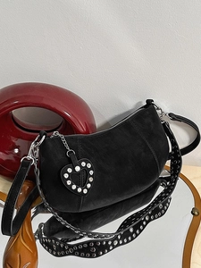 Black matte crescent bag with silver rivet strap and rhinestone heart charm accessory