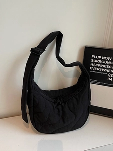 Minimalist black quilted crescent shoulder bag with adjustable strap for daily commute