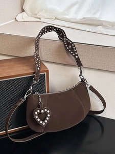 Minimalist dark brown dumpling cross-body bag with silver studs and heart charm