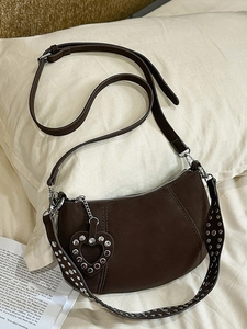Deep brown crescent dumpling bag with vintage texture and silver heart rivets decor