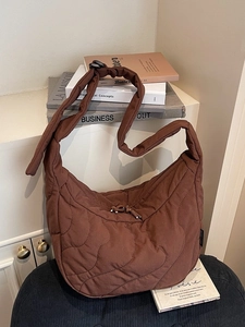 Dark brown quilted crossbody bag with a wide strap, ideal for casual and daily commute