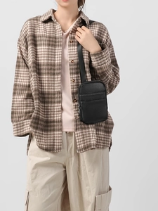 Minimalist black pebbled leather crossbody phone bag with zipper and front pocket
