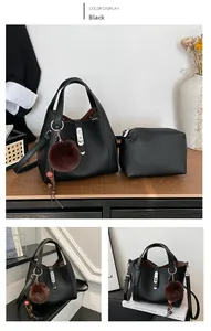 Detailed view of black lychee grain handbag with matching pouch and metal buckle clasp