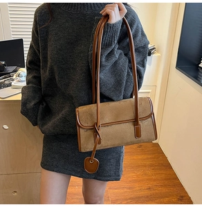 Detail of a brown suede and leather shoulder bag shown with a stylish casual outfit