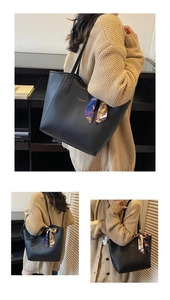 Detail of black leather tote bag with silk scarf handle and FASHION & BAGS logo