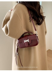 Minimalist deep red-brown leather crossbody bag shown on model for retro style styling