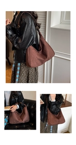 Detail of deep brown suede tote bag featuring a vintage hobo style and adjustable strap