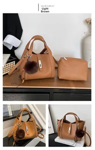 Detail of light brown bucket bag set with plush ball charm and beaded strap accents
