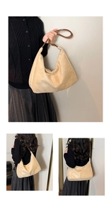 Detail of beige crescent tote bag featuring soft suede texture and brown leather strap