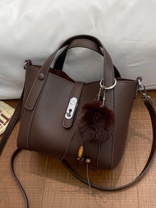 Vintage brown lychee grain bucket bag with rotating silver lock and fur ball charm