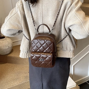 Brown quilted leather mini backpack with silver chain strap and metal swivel lock details