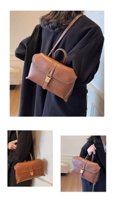 Detailansicht der braunen Vintage-Lederhandtasche mit Goldschnalle und Gurt