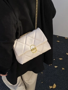 Quilted beige chain crossbody bag with gold-tone metal hardware and oval twist lock