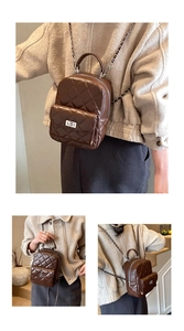 Detail of dark brown quilted mini backpack with metal chain straps and front pocket