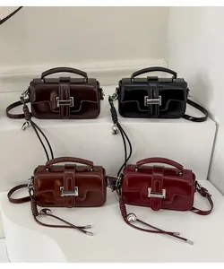 Detail of vintage square handbags in four colors featuring silver heart pendants