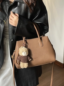 Borsa a mano marrone in ecopelle con tracolla regolabile e ciondolo a forma di orsetto