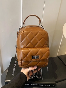 Brown quilted mini backpack for women featuring a metal turn-lock and chain straps