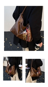 Close-up of brown PU leather tote bag featuring contrast stitching and cute bear charm