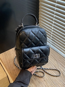 Classic black quilted mini backpack for women with silver chain strap and metal lock