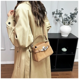 Chic khaki suede leather handbag with metal turn-lock closure shown on shoulder