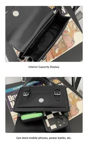 Internal double compartments of black matte leather crossbody bag showing large capacity