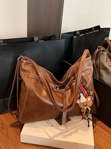 Grand sac cabas marron foncé avec coutures blanches et un joli pendentif ours tricoté