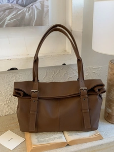 Retro dark brown large capacity faux leather tote bag for women in a cozy home setting
