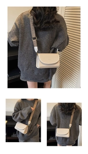 Détail d'un sac bandoulière beige à texture tissée avec une large sangle de style ethnique