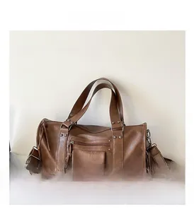 Detail of vintage brown pillow bag showing PU leather texture and stylish metal rivets