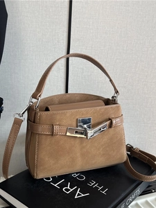 Deep tan trapezoid handbag with suede leather patchwork and silver twist-lock closure