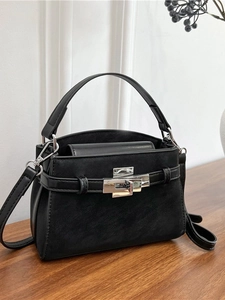 Chic black matte leather tote bag with silver twist lock and adjustable crossbody strap