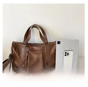 Deep brown retro satchel with multi-zipper pockets and tablet comparison for scale
