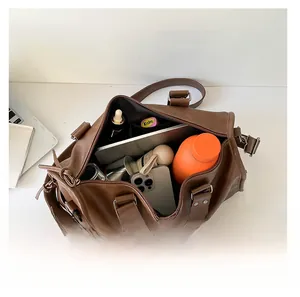 Top view of brown retro tote bag showing large capacity with laptop and accessories inside