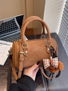 Vintage brown leather Boston bag with teddy charm and adjustable shoulder strap