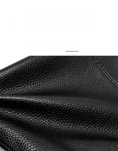 Close-up of black lychee grain leather texture with premium neat stitching detail