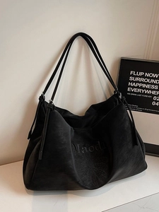 Minimalist large black faux suede tote bag with daisy embroidery and slim straps
