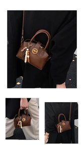 Detail showing vintage dark brown shell bag with ethnic bead charm and golden clasp