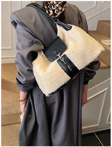 Detail of plush tote bag showing contrast textures of cream wool and black leather strap