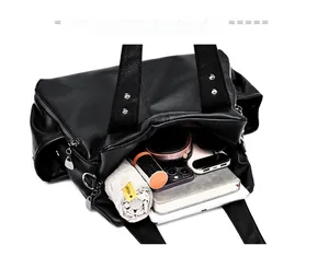Interior view of black pebbled leather tote showing ample space for tablets and umbrellas