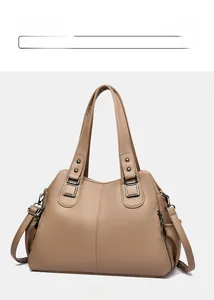 Detail view of the khaki hobo bag's litchi grain texture and metallic zippers