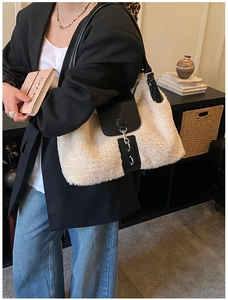 Detail of faux fur shoulder bag with black leather flap and silver metal buckle