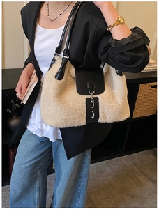 Detail of the soft faux fur shoulder bag with black leather flap and silver chain