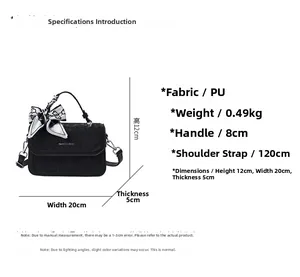 Detailed dimension guide for black textured crossbody bag with ribbon handle and size specs